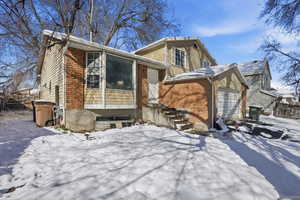 View of front facade with brick siding and an attached garage
