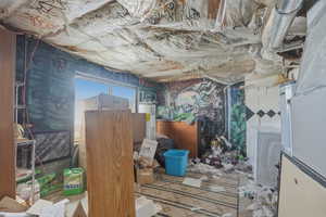 Miscellaneous room featuring heating unit, gas water heater, and washer / dryer