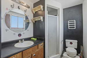 Full bathroom with vanity and a stall shower