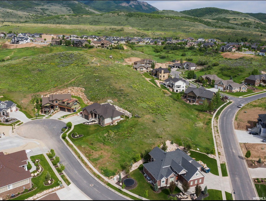 Aerial view of property's location featuring mountains and nearby suburban area