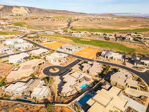 Aerial perspective of suburban area with a mountainous background and a golf course