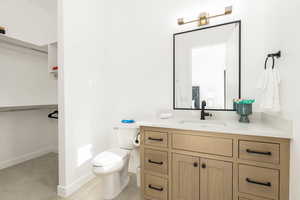 Bathroom with a walk in closet and vanity