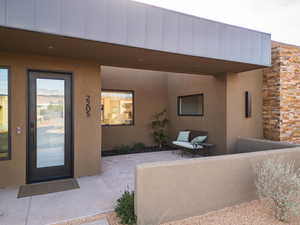 Doorway to property featuring stucco siding