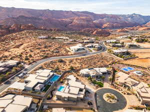 Aerial view of property's location with nearby suburban area and mountains
