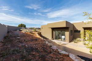 Back of property featuring stucco siding