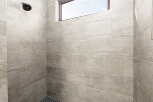 Bathroom featuring tiled shower