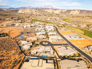 Aerial view of property and surrounding area featuring nearby suburban area