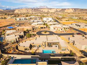 Aerial perspective of suburban area with a pool and a mountain backdrop