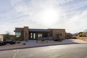 View of front of house with stone siding and stucco siding