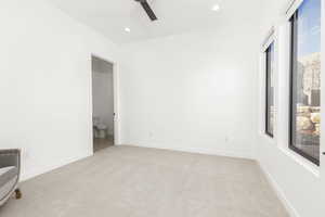 Empty room featuring light carpet, recessed lighting, and a ceiling fan
