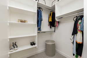 Walk in closet with light carpet