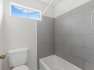 Bathroom featuring toilet and  shower combination