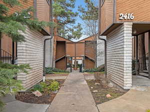 View of exterior entry featuring brick siding