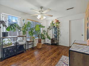 Dining area with a ceiling fan and dark wood-type flooring