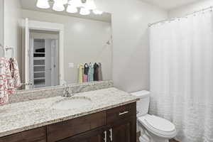 Full bathroom featuring vanity, a shower with curtain, and a walk in closet