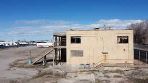 View of property exterior with stairs and a cooling unit