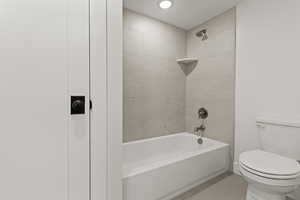 Full bathroom with  shower combination, light tile patterned floors, and recessed lighting