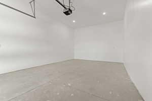 Garage featuring recessed lighting and a garage door opener