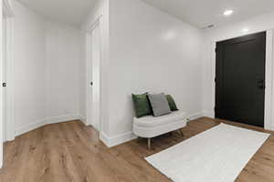 Foyer featuring light wood finished floors and recessed lighting
