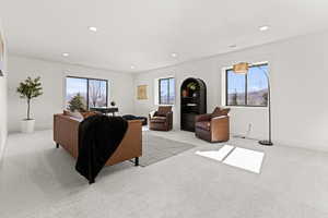 Living room featuring light colored carpet and recessed lighting