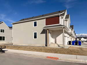 View of front facade with brick siding, an attached garage, and a mountain view