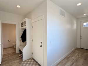 Entryway with recessed lighting and light wood finished floors