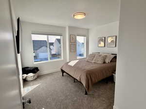 Bedroom with carpet flooring and a textured ceiling