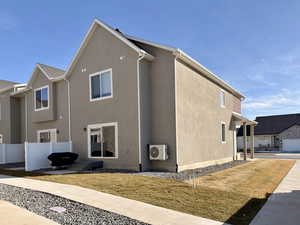 View of property exterior with a cooling unit and stucco siding