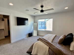 Bedroom featuring carpet flooring, recessed lighting, a ceiling fan, and a textured ceiling