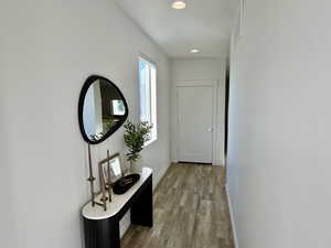 Hall featuring recessed lighting and light wood-style flooring