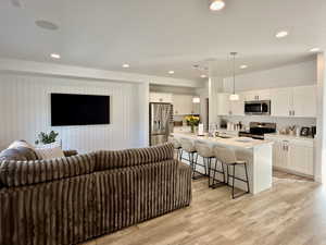 Living room featuring light wood-type flooring and recessed lighting