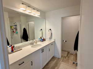 Bathroom featuring vanity, light wood finished floors, a textured ceiling, and a stall shower