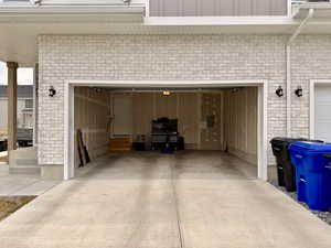 Garage with concrete driveway and electric panel