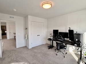 Carpeted office space featuring baseboards