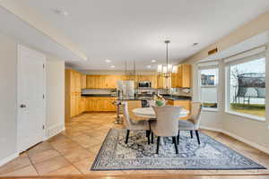 Dining space featuring a chandelier and light tile patterned floors