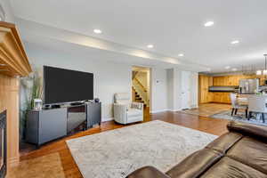 Living room with recessed lighting and light wood-type flooring