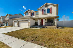 View of front of house featuring covered porch, stucco siding, concrete driveway, a garage, and a front yard