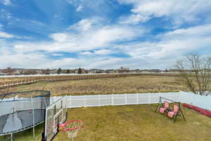 Fenced backyard with a trampoline