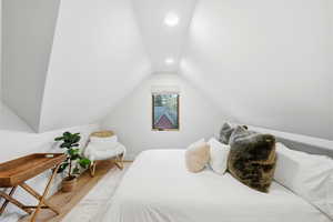 Bedroom with wood finished floors and recessed lighting