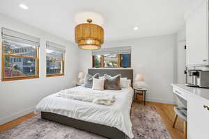 Bedroom with light wood-style flooring and recessed lighting