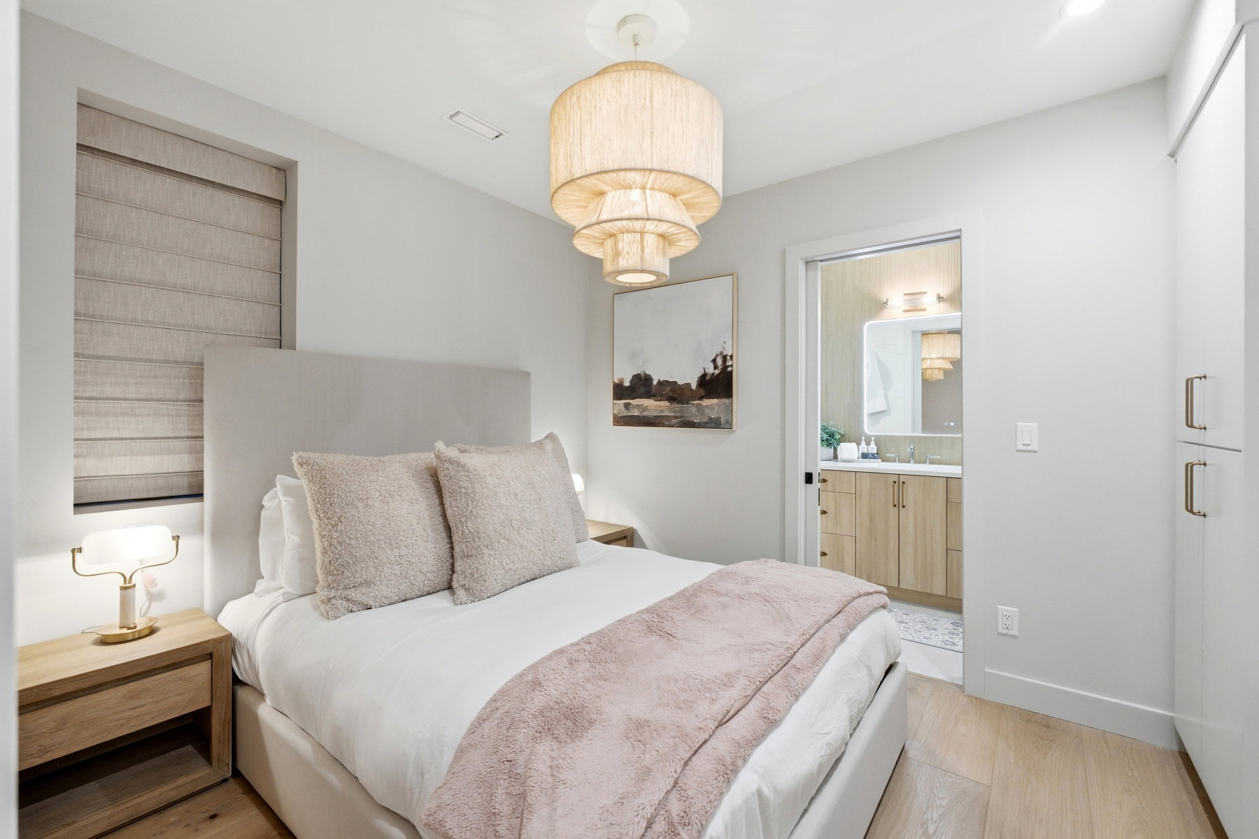 Bedroom with light wood-style flooring and baseboards