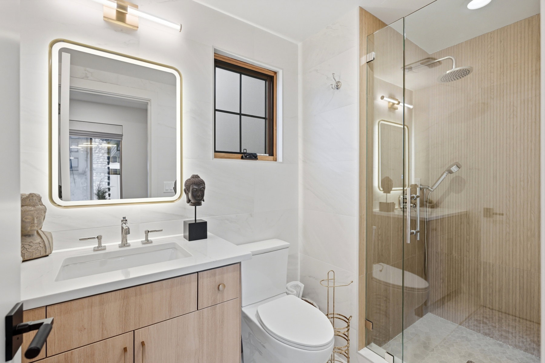 Bathroom featuring vanity, a shower stall, and tile walls