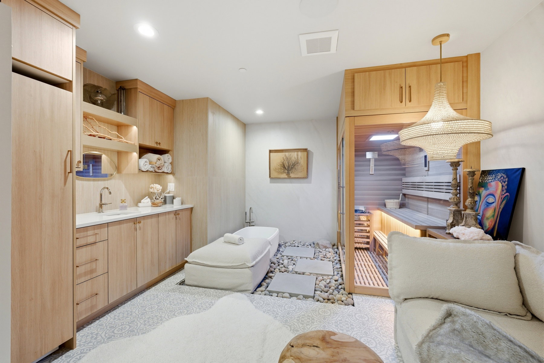 Kitchen with light wood finish cabinetry, open shelves, light countertops, decorative light fixtures, and modern cabinets