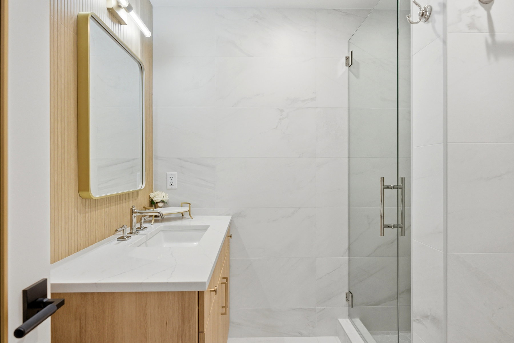 Full bath featuring vanity and a marble finish shower