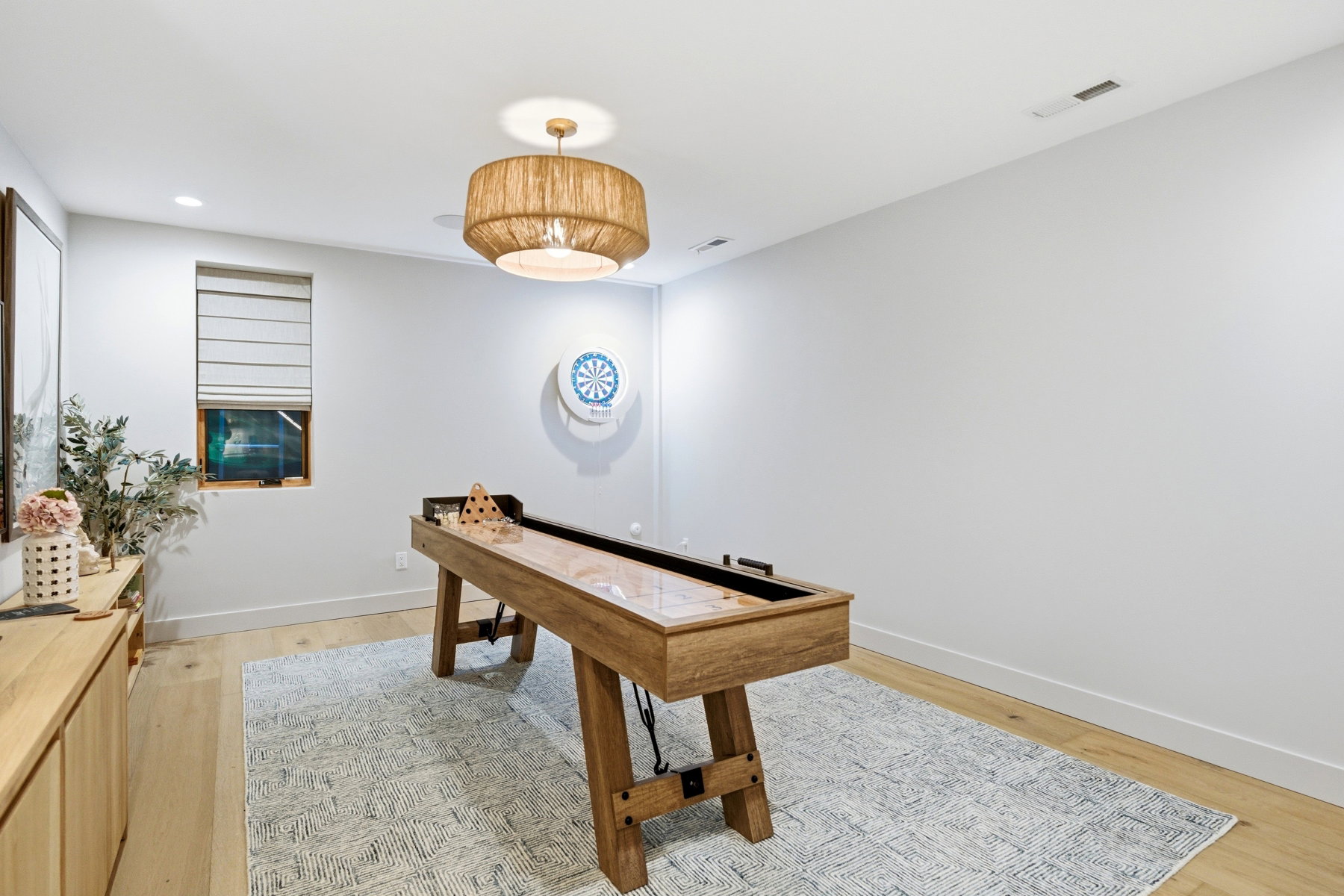 Playroom with light wood-style floors and recessed lighting