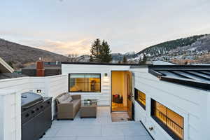 View of patio with a mountain view and outdoor furniture