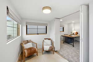 Living area with carpet floors and recessed lighting