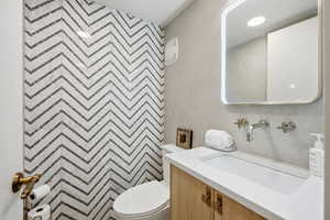 Bathroom featuring vanity and tile walls