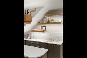 Bar featuring open shelves and gray cabinets