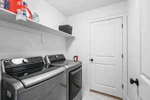 Laundry room featuring washer and clothes dryer